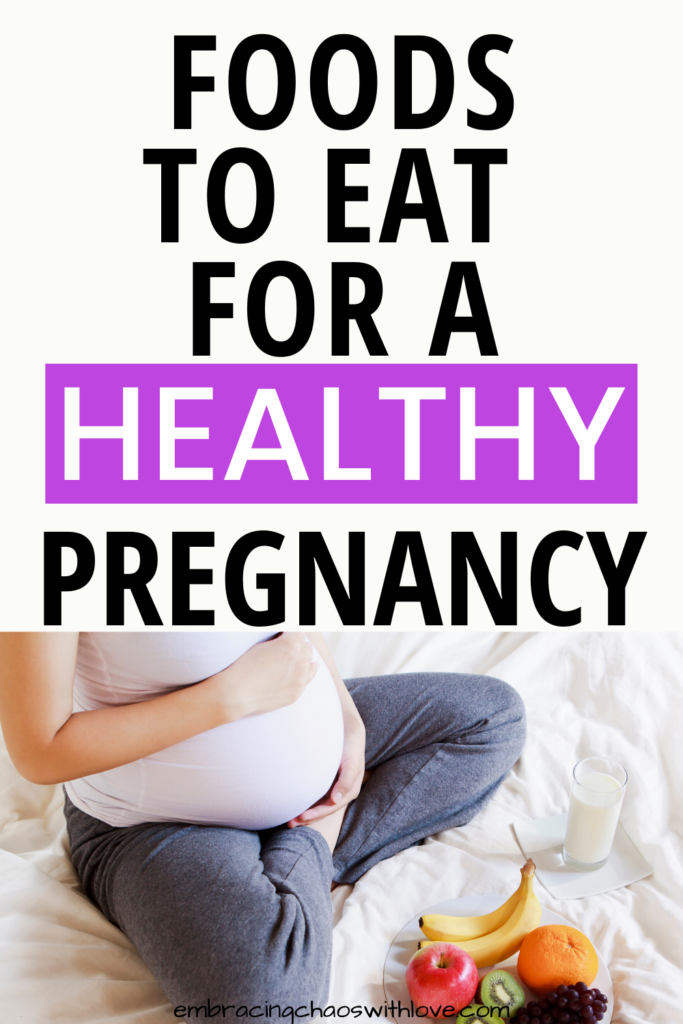 pregnant woman sitting with plate of healthy food