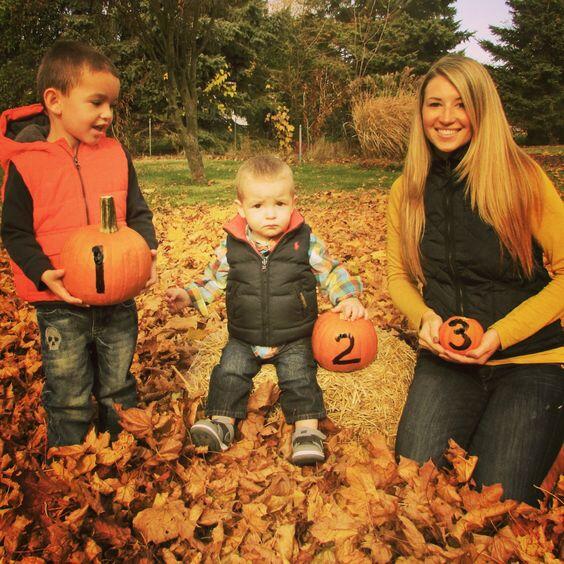 baby announcement with siblings and pumpkins